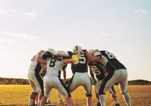 Group,Of,Young,American,Football,Players,Standing,In,A,Huddle