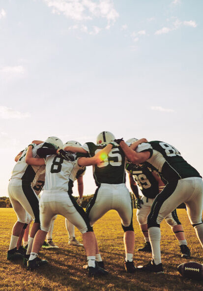 Group,Of,Young,American,Football,Players,Standing,In,A,Huddle