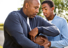 Father,And,Son,Playing,Football,And,Spending,Time,Together.